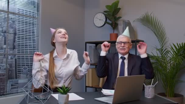 Two joyful collegues in formal suits dancing victory dance, celebrating success of business project - Footage, Video