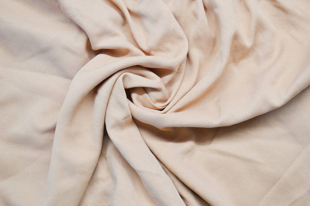 Light pink textile pattern as a background. Close up on Light pink material texture on fabric. crumpled fabric texture - 写真・画像