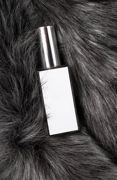 White Perfume Bottle on gray fur background - 写真・画像