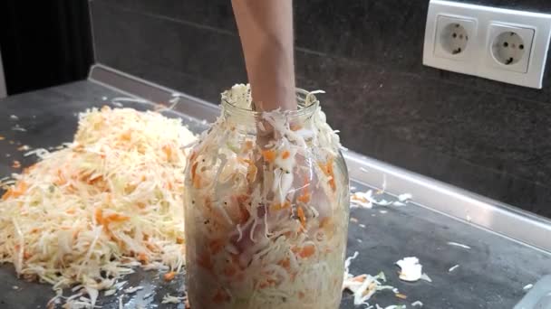 Woman preparing fresh vegetables for fermentation on table. Woman puts sauerkraut in a jar. HD video footage 1920x1080 - Footage, Video