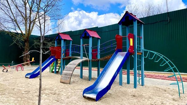 A bright beautiful playground, it glows in different colors under the bright rays of the summer sun. Fun children's entertainment on the playground. Empty playground. - Photo, Image