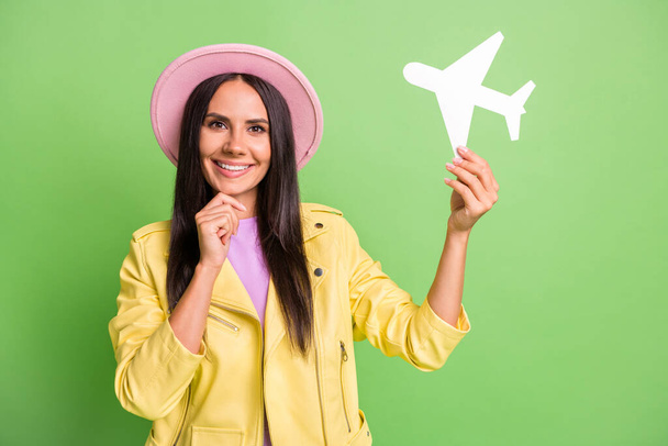 Photo portrait of smart thoughtful woman smiling thinking about journey travel in pink hat isolated on bright green color background - Φωτογραφία, εικόνα