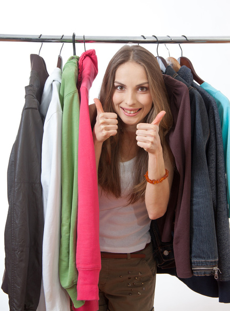 Young woman near rack with hangers - Photo, Image
