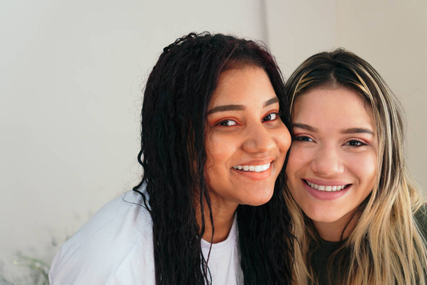 Two Hispanic friends smiling. Two girls at home smiling - Fotó, kép