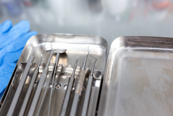 Dental instruments and medical gloves on the table - 写真・画像