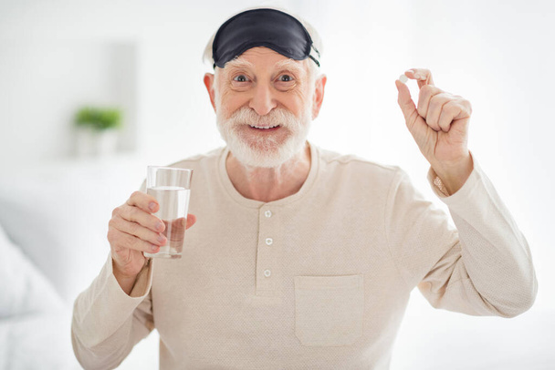 Photo of awake elderly man pensioner happy positive smile drink morning pill health healthcare indoors - Photo, image