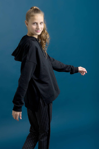 Pretty teenage girl in black stylish clothes - Фото, изображение