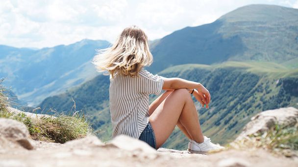 Woman hiking in mountains at sunny day time - Photo, Image