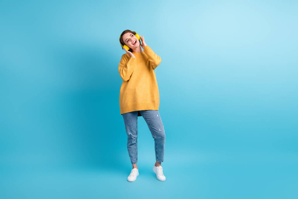 Full length body size photo of girl listening music earphones singing song wearing stylish outfit isolated on bright blue color background - Foto, Imagem