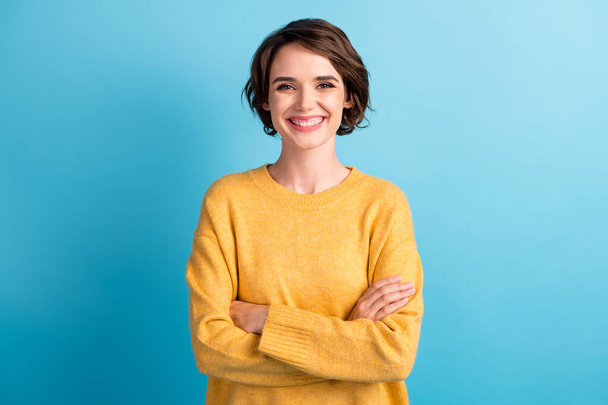 Photo portrait of cheerful happy female student with folded hands smiling isolated on bright blue color background - Foto, Imagem