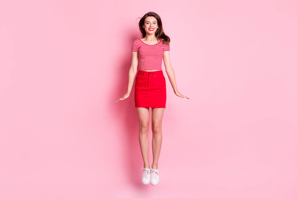 Full size photo of young beautiful smiling cheerful charming girl with red lipstick jump fly isolated on pink color background - Photo, Image