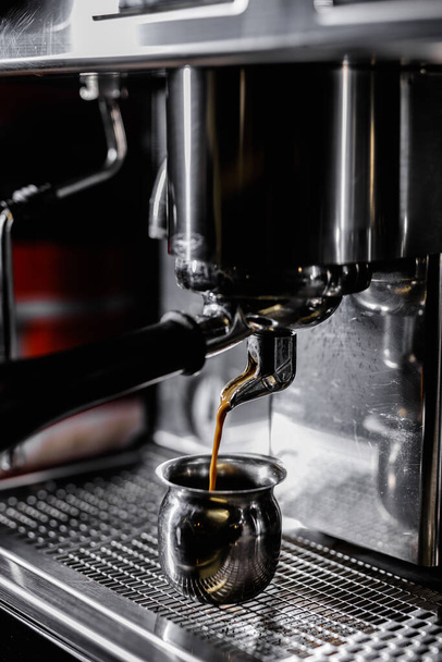 Close-up of professional coffee machine. Pouring espresso. Barista preparing deliciouse fresh hot coffee - Zdjęcie, obraz