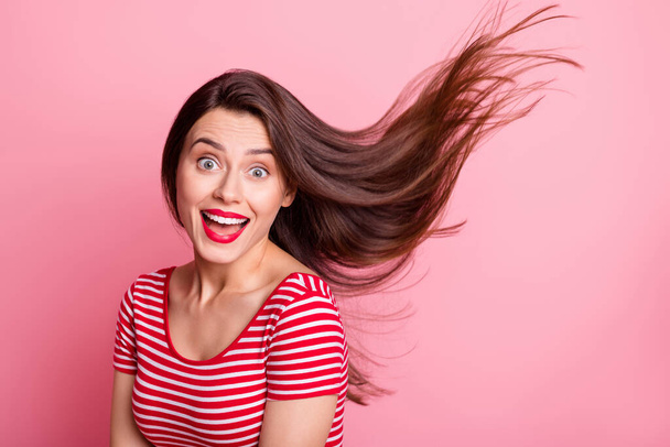 Portrait of young beautiful excited smiling good mood girl open mouth flying hair isolated on pink color background - Foto, Imagem