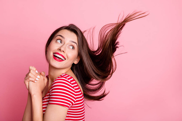 Photo of young beautiful smiling positive adorable girl look copyspace flying hair isolated on pink color background - Φωτογραφία, εικόνα