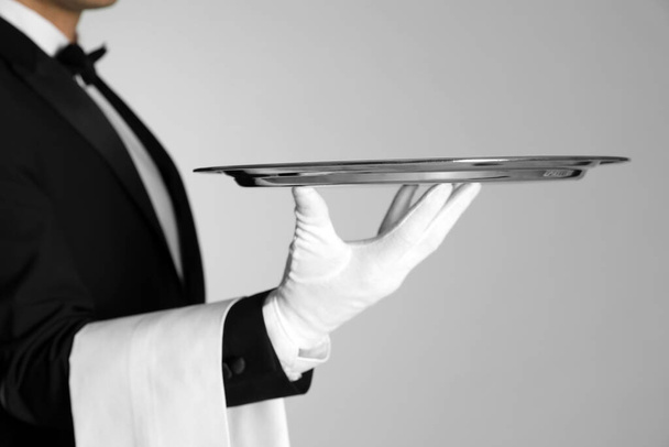 Butler with tray on light grey background, closeup - Фото, зображення