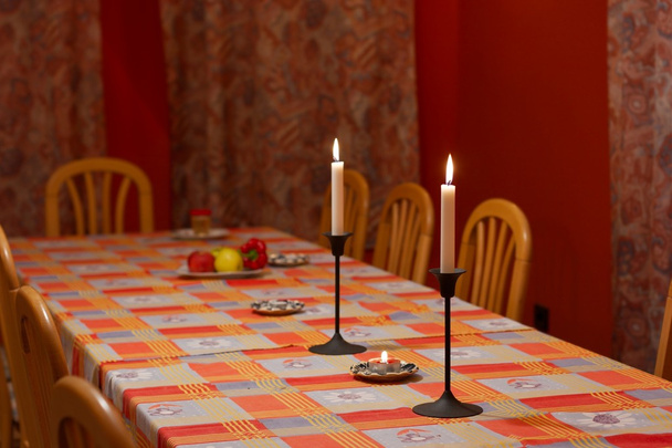 Big dining table with soft candle light - Foto, Bild