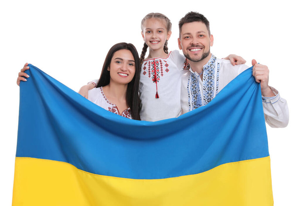 Happy family in national clothes with flag of Ukraine on white background - Valokuva, kuva