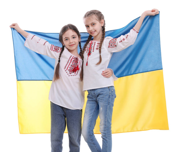 Happy girls in national clothes with flag of Ukraine on white background - Zdjęcie, obraz