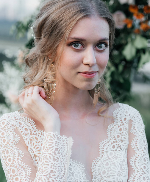 lovely beautiful young slender bride in an airy elegant white wedding dress with lace smile gentle - Zdjęcie, obraz