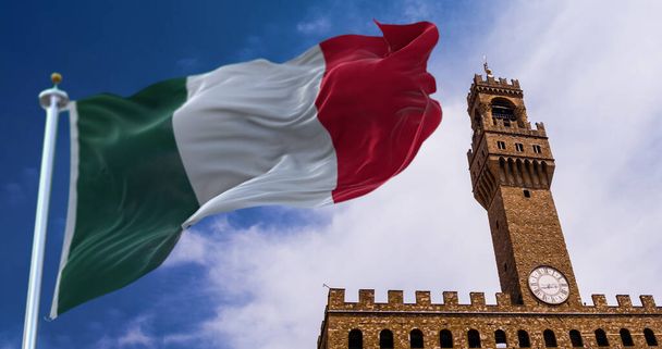 背景にフィレンツェのヴェッキオ宮殿の塔と風に揺れるイタリアの旗。旅行や観光地。芸術と建築。世界的に有名なイタリアの歴史的建造物 - 写真・画像