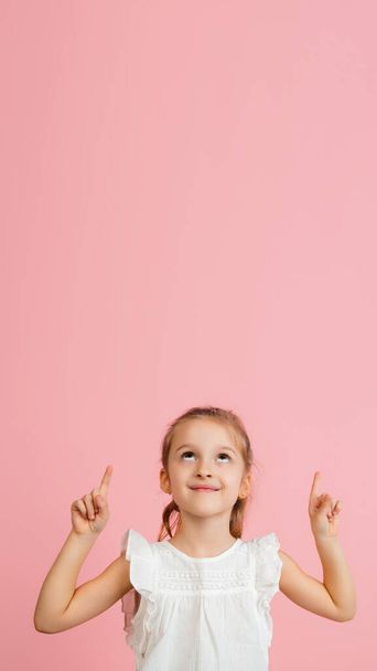 Pretty caucasian girl portrait isolated on pink studio background with copyspace - Foto, immagini