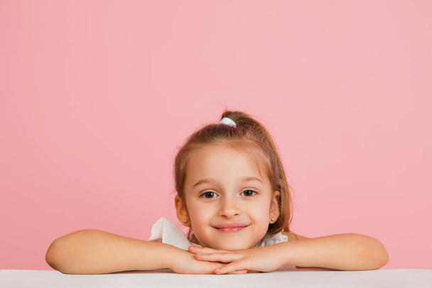 Pretty caucasian girl portrait isolated on pink studio background with copyspace - Φωτογραφία, εικόνα