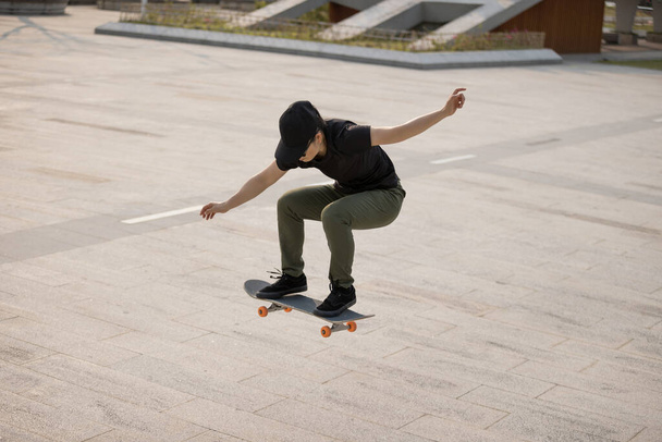 Skateboarder skateboarding outdoors in the morning - Фото, изображение
