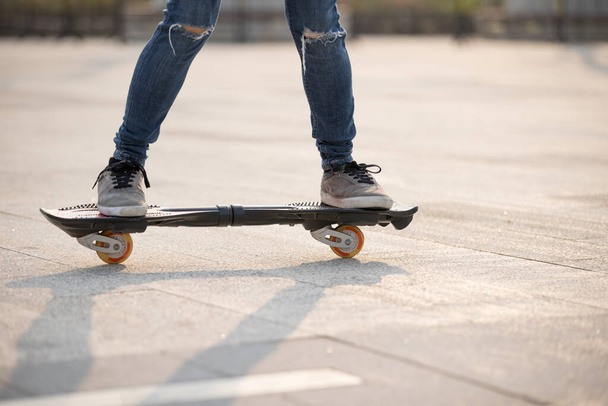 Skateboarder legs skateboarding at outdoors - Foto, Imagen