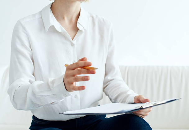 woman indoors in shirt with document folder in hands mockup - Foto, Imagem