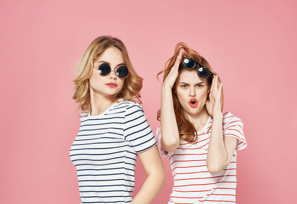 Two girlfriends in striped t-shirt glasses fashion luxury lifestyle - Foto, imagen