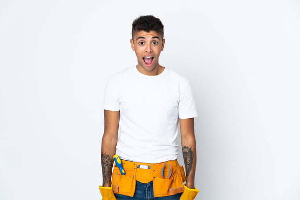 Young Brazilian electrician manipulated isolated on white background with surprise facial expression - Photo, Image