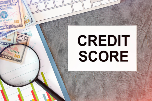 Credit Score is written in a document on the office desk with office accessories, keyboard and diagram - Photo, Image