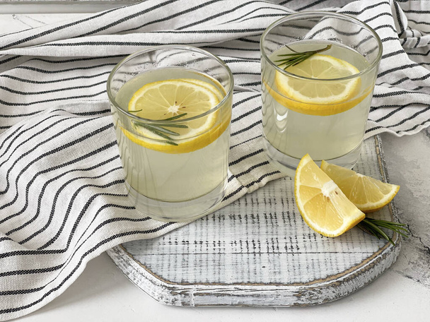 lemonade and rosemary and ginger on a white tabl - Photo, Image