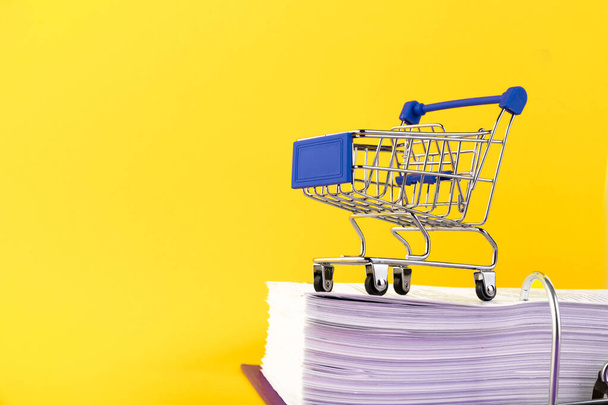 Shopping cart. Shopping online concept. e-commerce, yellow background. Copy space. - Fotografie, Obrázek