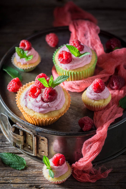 Pink muffin made of cream and fruits. Vanilla cupcake with fruit. Homemade sweets. - Foto, imagen