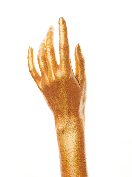 Hands in gold paint. Golden fingers. Female hand isolated on white background. White woman's hand showing symbols and gestures. - Photo, image