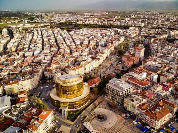 Αεροφωτογραφία της πρωτεύουσας της επαρχίας Αϊντίν - πόλη Αϊντίν από το υψηλό σημείο της πτήσης μη επανδρωμένου αεροσκάφους σε ηλιόλουστη μέρα στην Τουρκία. Καταπληκτική θέα εναέρια cityscape από τα πουλιά πετούν υψόμετρο στο όμορφο κέντρο της πόλης και πάρκα. - Φωτογραφία, εικόνα