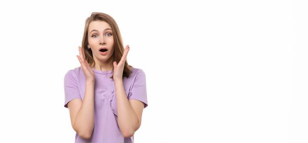 astonished girl shouting wow with open mouth, isolated on white background. True human reactions, emotions and feelings - Photo, Image