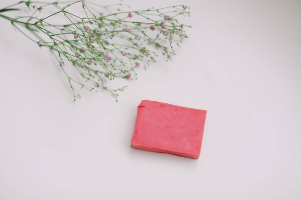 Natural handmade soap bar and flowers, spa organic soap on white background - 写真・画像