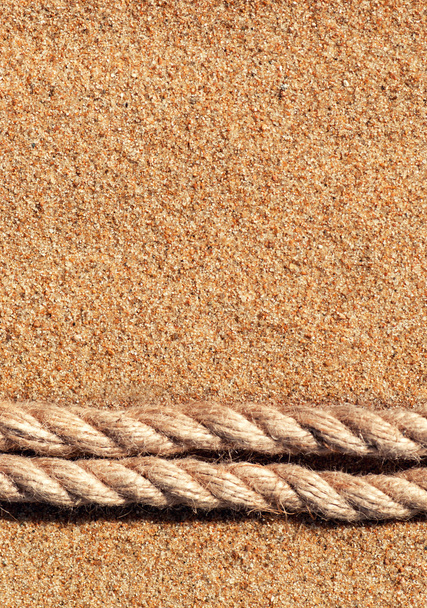 zand achtergrond met touw - Foto, afbeelding