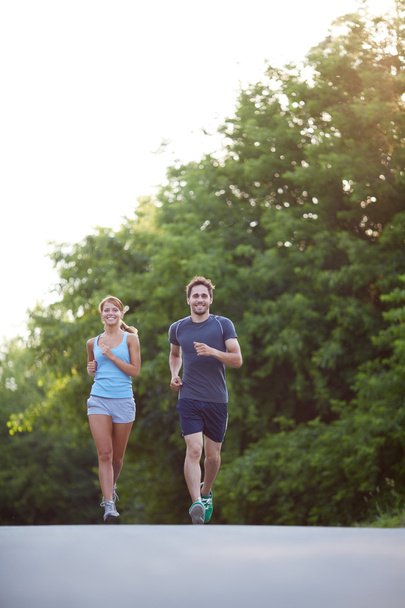 Couple running outdoors - Photo, Image