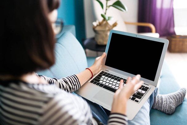 Beautiful  woman working on laptop at home. Black screen on laptop. Technology, freelance, shopping online, remote work, E learning concept.  - Fotoğraf, Görsel