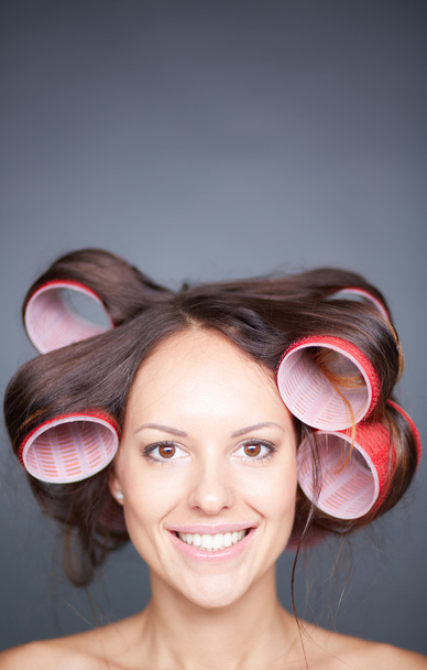 Woman with hair curlers - 写真・画像