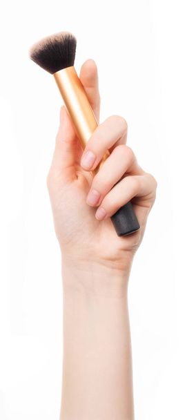  A woman's hand holding a makeup brush. - Foto, Imagen