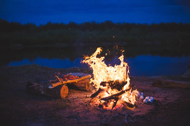 Campfire on a beach in the night - Фото, изображение