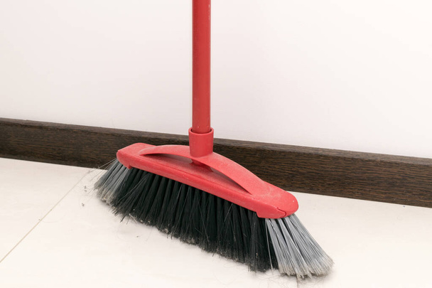 View of the red sweeping brush in the kitchen - Photo, Image