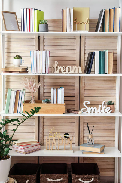 Shelf unit with books and decor in interior of room - Photo, Image
