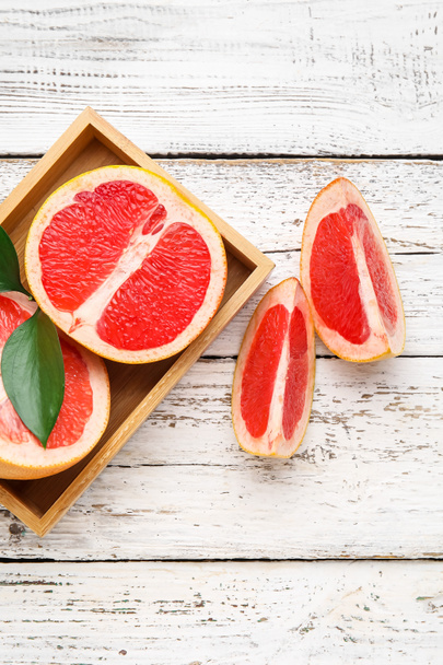 Fresh grapefruits in box on white wooden background - Photo, Image