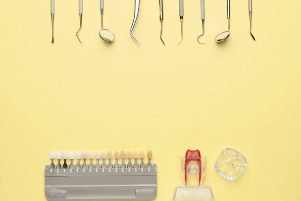 Werkzeuge des Zahnarztes, Modell von Zahn- und Zahnproben auf farbigem Hintergrund - Foto, Bild