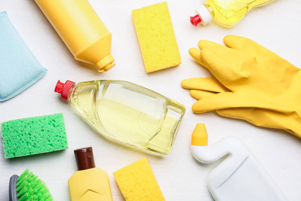 Set of cleaning supplies on light wooden background - 写真・画像